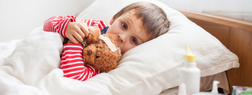 cancro pediatrico, un bambino a letto con un pupazzo di peluche tra le braccia