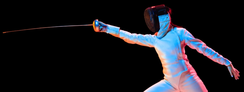 teen girl in fencing costume with sword in hand isolated on black background diabete