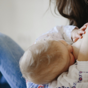 post partum: a baby breastfeeding a woman