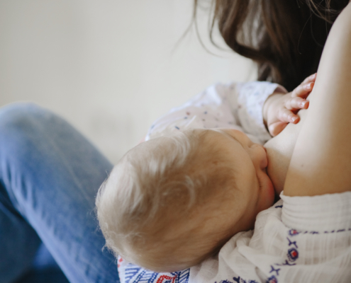 post partum: a baby breastfeeding a woman