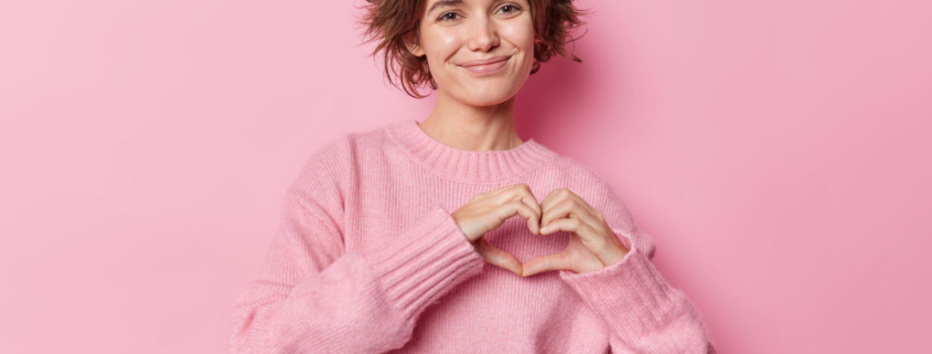 salute e visite gratuite, una donna mostra il simobolo del cuore